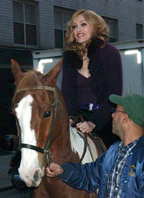 Madonna riding a horse