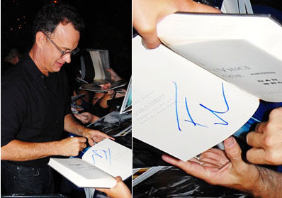 Tom Hanks signing an autograph