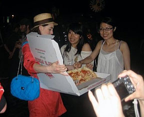 Anne Hathaway serving pizza