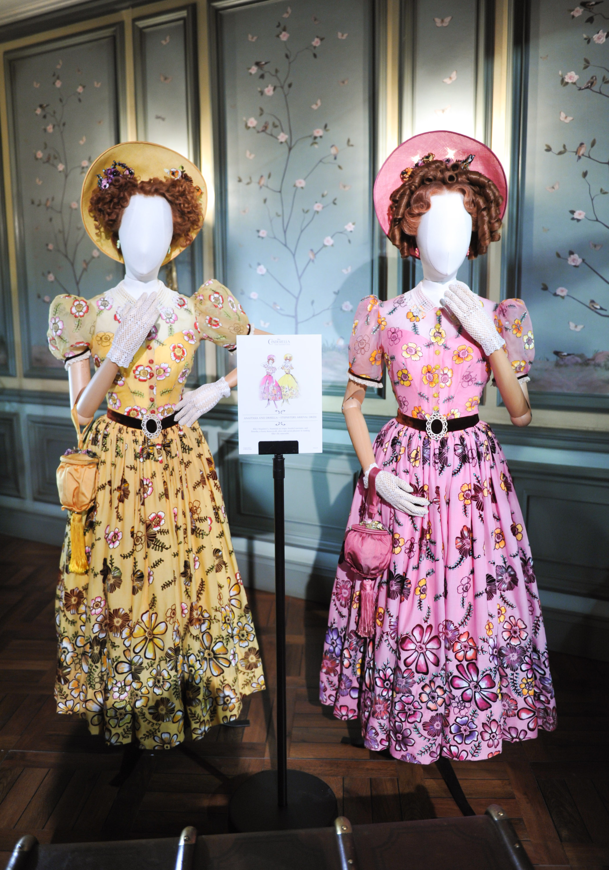 In the Entrance Hall, there were mannequins dressed in the costumes worn by Cinderella’s two stepsisters, Anastasia (played by Holliday Grainger) and Drisella (Sophie McShera). The girls were dressed in their arrival dresses, which featured handpainted flowers and different textures using a process called flocking.