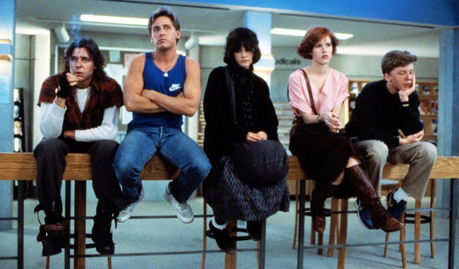 The Breakfast Club is about a single day in the lives of five teenagers (brat packers Molly Ringwald, Emilio Estevez, Judd Nelson, Ally Sheedy, Anthony Michael Hall). Each representing a different high school cliché, they are serving Saturday detention together in a giant empty library. What kind of detention is that? Where is this school? […]