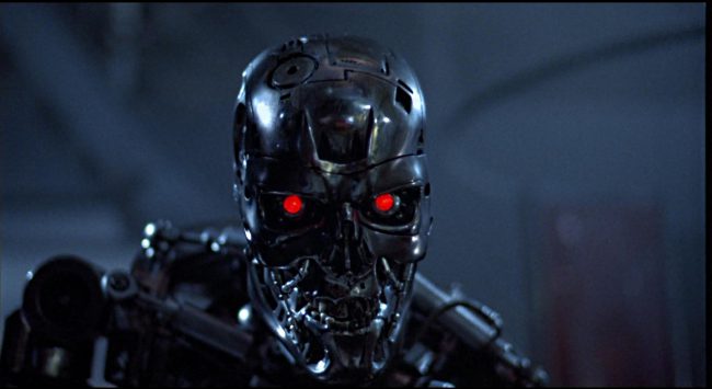 There’s another way the first film in the blockbuster franchise might have ended. Rather than Sarah being wheeled off in an ambulance to an uncertain future, the alternate ending for The Terminator had the microprocessor chip (i.e., the brain) of the T-800 being found by scientists investigating the scene after the epic final battle between […]