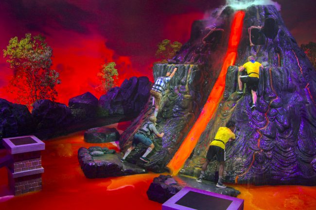 Teams compete to navigate obstacles across rooms flooded with lava by leaping on chairs and climbing ropes. New this season: a very slippery volcano.