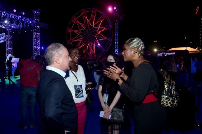 Special guest Tiffany Haddish talks with Alan Bergman, Disney Studios Content Chairman during the afterparty.  