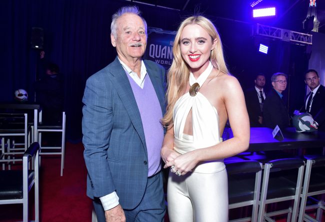Kathryn Newton (Cassie Lang), wearing a white Rodarte pantsuit, and Bill Murray (Krylar) pose inside the Regency Village Theatre in Westwood, California at the Ant-Man and The Wasp: Quantumania world premiere.