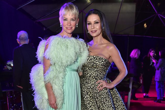 Evangeline Lilly (Hope Van Dyne) wearing Giambattista Valli Haute Couture, poses with Catherine Zeta-Jones, who wore a Carolina Herrera gown at the Ant-Man and The Wasp: Quantumania world premiere in Westwood, California.