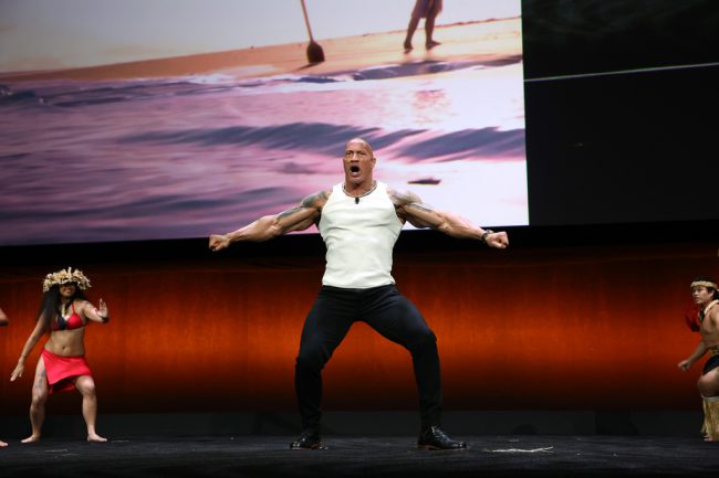 Dwayne Johnson performs onstage with dancers to present Moana 2 during the Walt Disney Studios presentation at Cinemacon. (Photo by Jesse Grant/Getty Images for Disney)